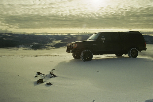 Black truck driving on snow