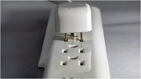 A power strip with a cord plugged in