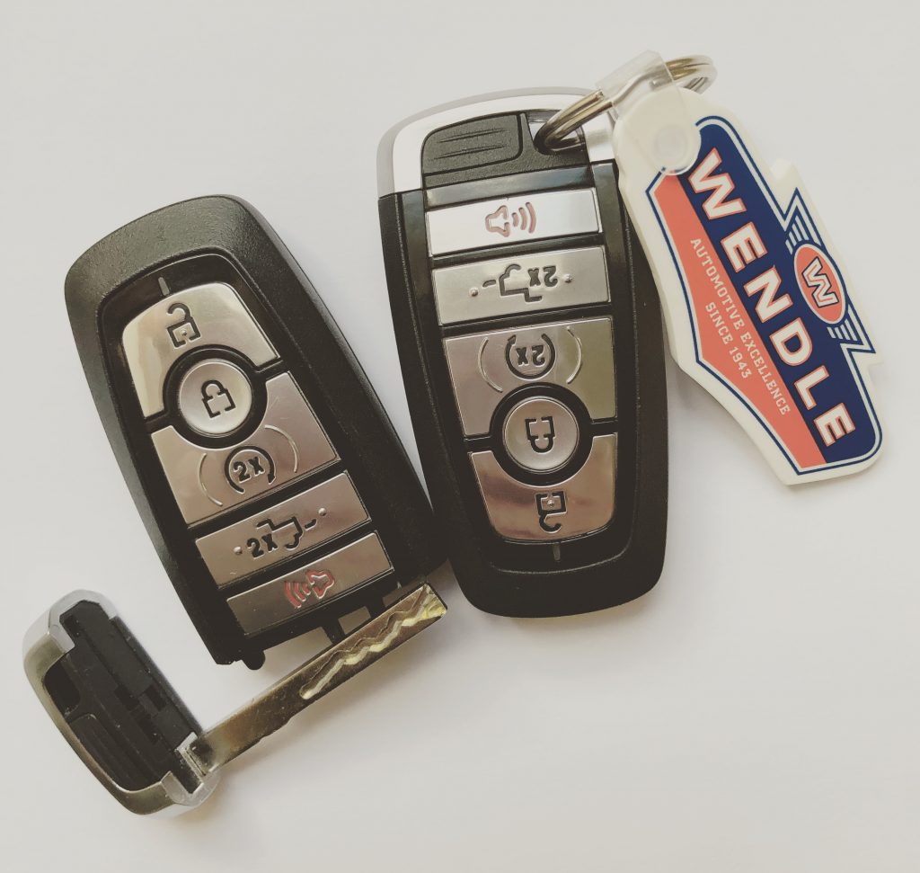 Two sets of Ford key fobs with one key removed and a Wendle key chain.