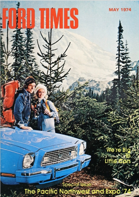 Two people standing by a blue car