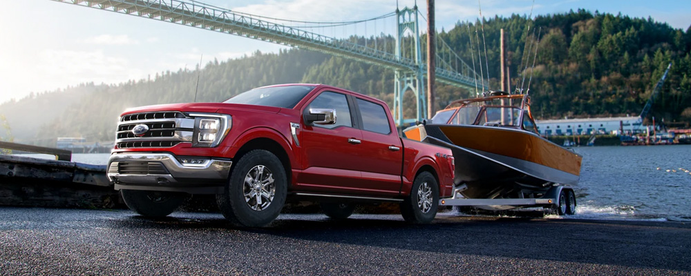 A red truck towing a boat